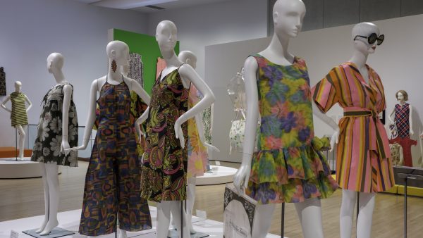 Image of the galleries at the Phoenix Art Museum that show several colorful paper dresses on view