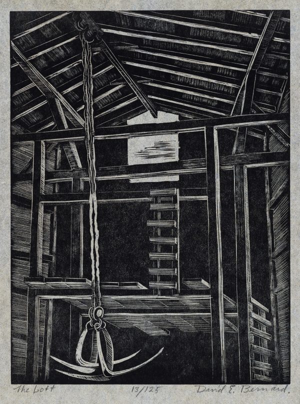An interior of a two story wooden barn. A hay claw dangles from rope in front of the hay loft. The loft has a ladder to a widow where the hay is raised and lowered into the barn.