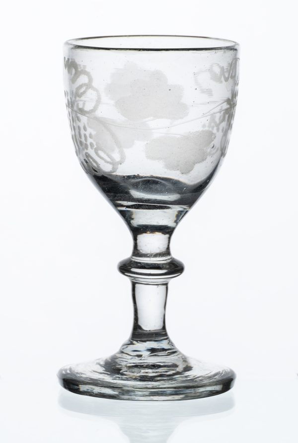 Clear glass cordial with acid etched grape vine pattern on bowl