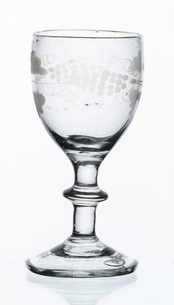 Clear glass cordial with acid etched grape vine pattern on bowl