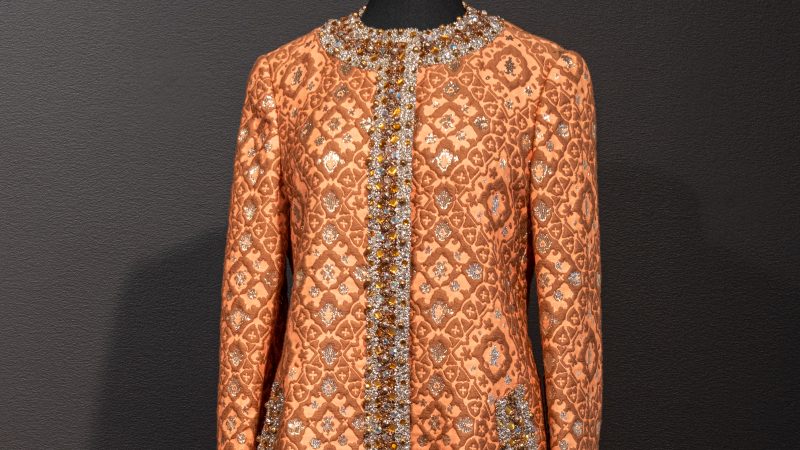 Photo of an orange, brown and gold brocade cocktail dress with beads