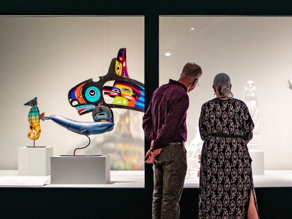 Photograph of an older couple admiring the Clearly Indigenous Exhibit
