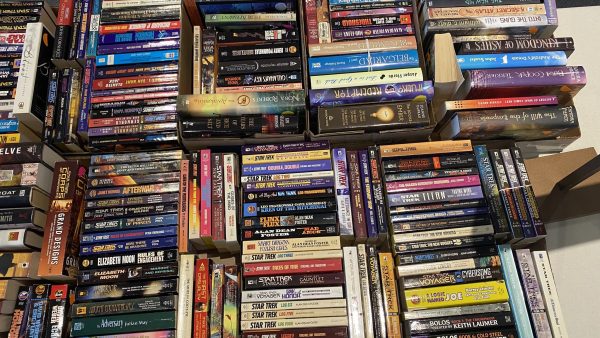 Boxes of books on a table, StarTrek and other sci-fi literature.