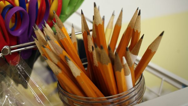 Photograph of sharpened pencils in a glass jar.