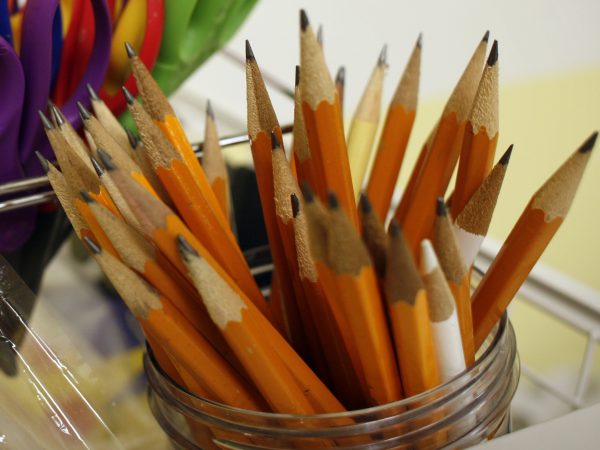 Photograph of sharpened pencils in a glass jar.