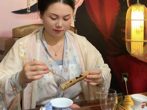 Asian woman making tea in a studio.