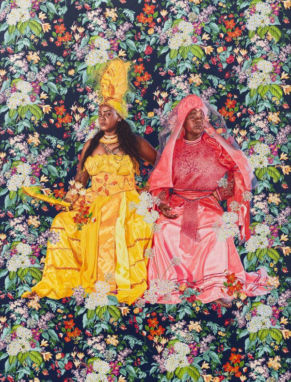 Portrait of Yaima Polledo & Isabel Pozo (2023) is an oil on linen work showcasing two regal, seated Cuban women wearing yellow and pink dresses with coordinating hair pieces and headscarves. The subjects are dressed for celebration and they appear entirely at ease. Wiley’s careful application of oil paint allows the light to catch their eyes and cheekbones; the women take center-stage alongside their intricately patterned formalwear. A background of lush greenery and blooming flowers surrounds the subjects and pushes forward, engulfing the viewer, too, as Polledo and Pozo tilt their chins just slightly and make eye contact with their audience. From far away, the public might expect to see European royalty based on the posing alone—yet through this composition Wiley offers something entirely unique. The result is intimate, captivating, and rife with detail. The women wear gold rings and immaculate lace, their open hands beckon; a lone bare foot with rose-gold painted nails appears in the composition, setting the tone for the soiree. (Charles Moore, Brooklyn Rail)