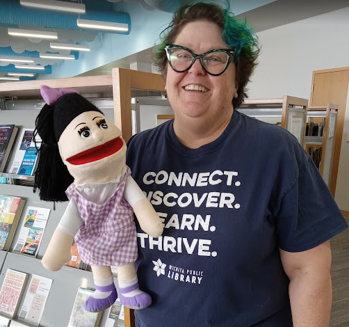 alt= image of Racine Zackula holding a puppet